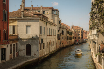 Motor boat navigates canal venice