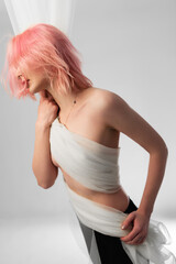 Obraz premium Girl with pink hair with a transparent white cloth. Tenderness.