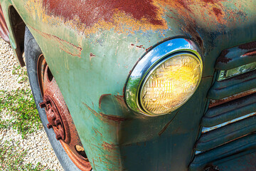 Beautiful headlight on a rusty truck