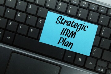 laptop keyboard, colored paper with the word strategic hrm plan