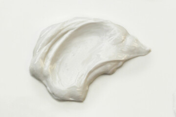 Blob or smear of white cream on a white background