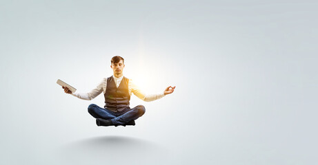 Business man doing yoga in lotus pose