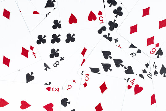 Pattern, playing cards of different suits as a background or backdrop, casino card games or poker.