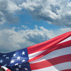 USA flag on a background of blue sky. National holidays concept