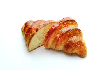 Croissant split into two parts on a white background