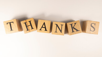 Obraz premium The word Thanks was created from wooden cubes.