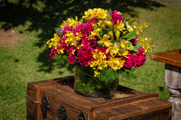 Decoração de flores coloridas com baús de madeira.