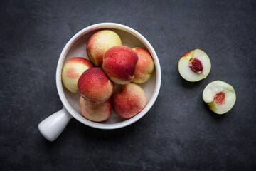 Fresh peaches on a dark gray background