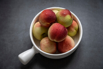 Fresh peaches on a dark gray background