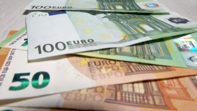 Manual counting of euro banknotes.Cash 50 euro bills.Accounting for fifty euro banknotes.Cash background in euros.European banknotes are a tangential policy.Wealth or debts in foreign currency.Money