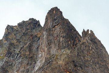 Jagged mountain peaks in northern Canada on a cloudy day with stunning landscape background. 