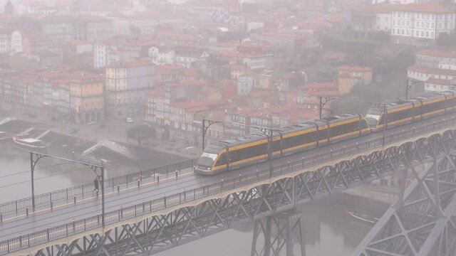 Establishing Shot Of the Aerial Subway in Porto over the Luís I Bridge on a Foggy Morning Day