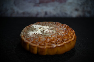 English translation of the Chinese-fortune-badly moldy moon cake with a damaged wall at background horizontal compsition