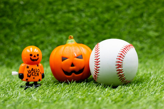 Baseball for Halloween Day on green grass with ghost