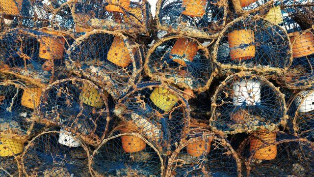 Pile of traditional crab, lobster traps at the harbor of Essaouira, Morocco.