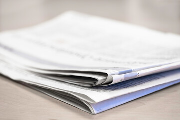 Newspaper on a wooden table, with shallow depth of field