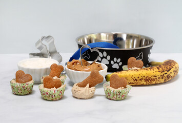 Dog biscuit ice cream cookies with ingredients and dog bowl.  Copy space.