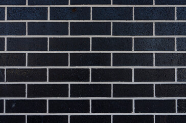 Black brick wall with white mortar.