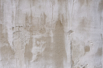 The texture of a gray concrete wall. The background of old cement plaster. Gray wall surface