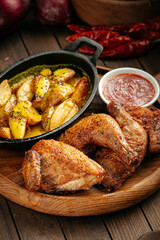 Rustic roasted chicken with potatoes and red sauce