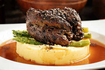 Grilled beef pepper steak with mashed potatoes and asparagus