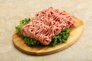 Raw pork minced meat over board