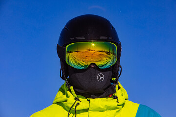 man in helmet and ski mask. reflection. winter activity