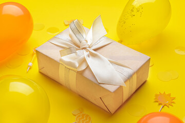 Fototapeta na wymiar Gift box, balloons and confetti on color background, closeup
