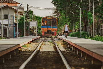 Fototapeta premium Train is on railway at Bangkok Railway Station is the main railway station in Bangkok and Railway station to across the country. background is building downtown. 