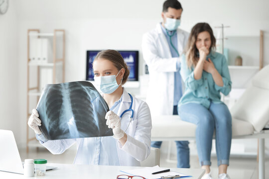 Female doctor with x-ray image of lungs in clinic