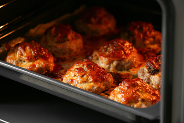 Baking tray with delicious minced meat boats, mushrooms and melted cheese in oven