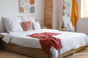 Fototapeta na wymiar Stylish interior of modern bedroom with mirror