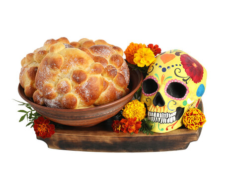 Bread of the dead and painted skull on white background. Celebration of Mexico's Day of the Dead (El Dia de Muertos)