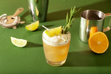 Glass of tasty whiskey sour cocktail on color background