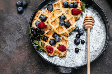 breakfast.Belgian waffles with berries and honey