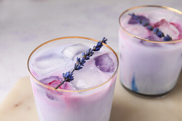 Glasses of fresh cocktail with lavender on light background, closeup