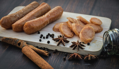 Sausage Or Guan Chiang and Herbs on the board, serving good beer snacks on a dark background.