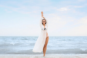 Fototapeta na wymiar Beautiful young woman on sea beach