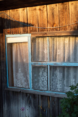 Facade of a vintage wooden building under the rays of the spring sun, sunset