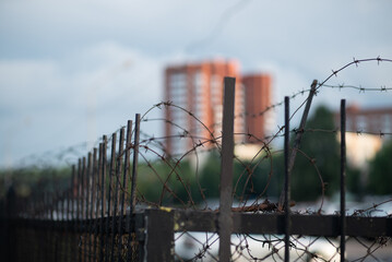 Territory fenced with barbed wire under protection in the city
