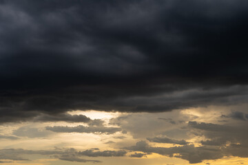 Black clouds and orange sky in the evening that it's about to rain.