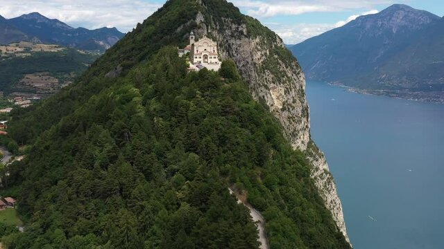 Aerial panorama of the Eremo di Montecastello church on Lake Garda. Catholic church on a mountain surrounded by the Alps.