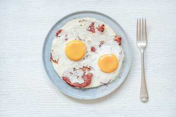 fried eggs with bacon on the table for breakfast