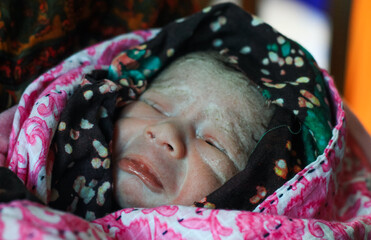 Beautiful baby boy a few seconds after the birth. Baby crying after birth.