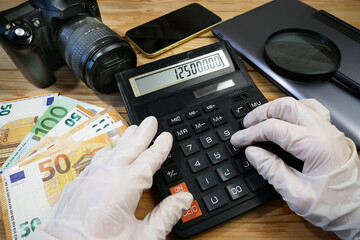 laptop, calculator, digital camera and money, store selling photographic equipment, pawnshop concept