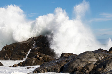 Fototapeta na wymiar Huge wave crashes on rocks