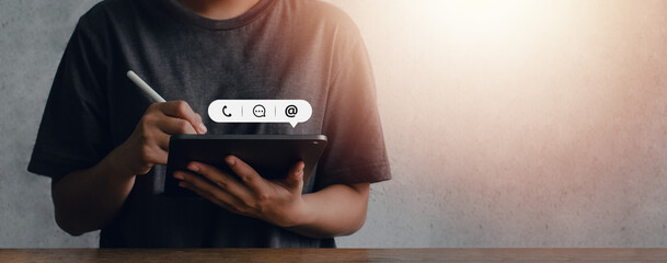 Hand of Business contact us service. Young woman holding iPad with communication icon, talk (email, phone, email), customer support concept. copy space