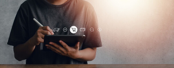 A young woman is shopping online with an application on an iPad. with modern online icons © Dee karen