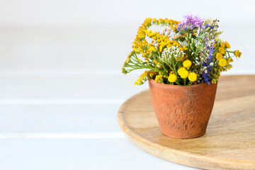 Bouquet of wild flowers in ceramic vase.