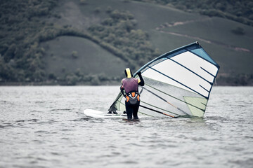 Windsurfer surfing on a windy day at the river.